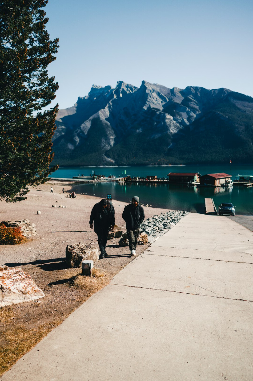 Group of seniors walking by a lake with mountains