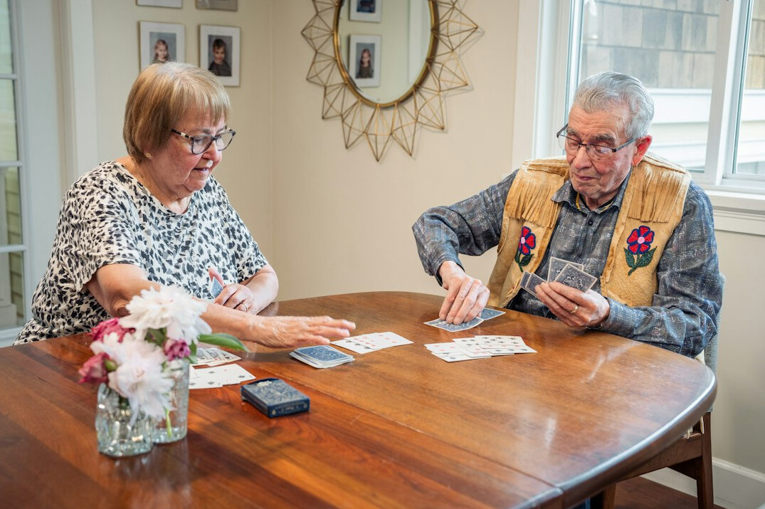 group of elderly playing cards