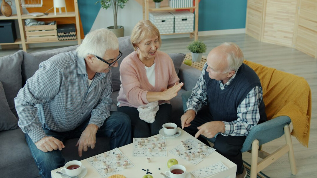 senior friends chatting in community room