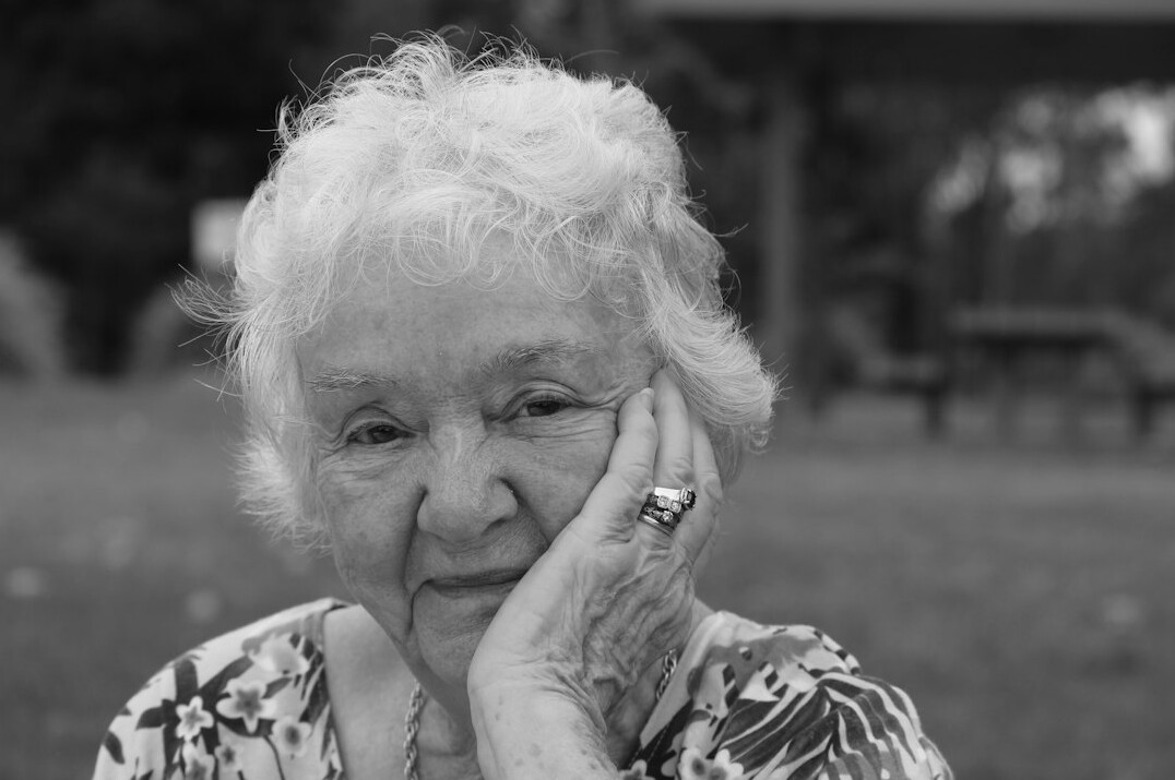 Cheerful senior woman with curly white hair portrait