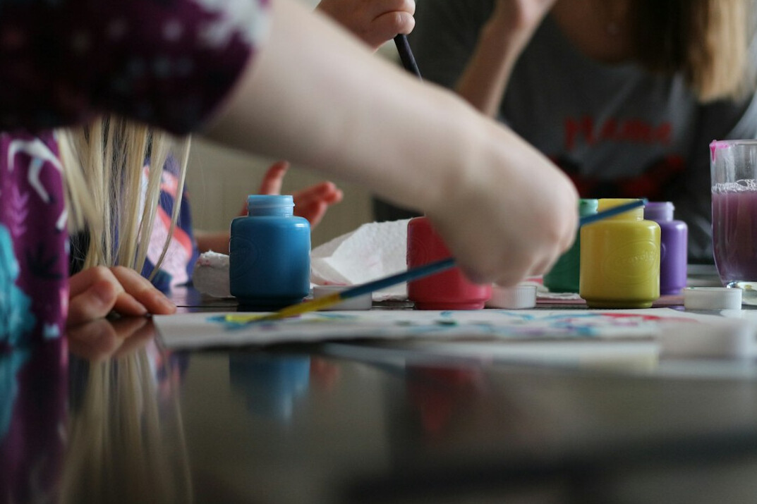 Group of seniors painting watercolors together at a table